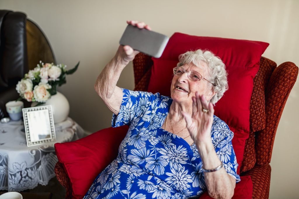 Assisted Living framework - elderly lady using mobile phone